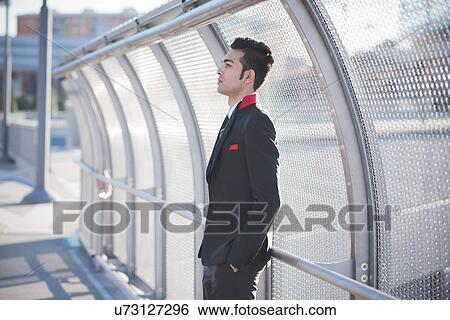 Young businessman by bridge safety fence View Large Photo Image Stock Photograph - Young businessman by bridge safety fence. Fotosearch