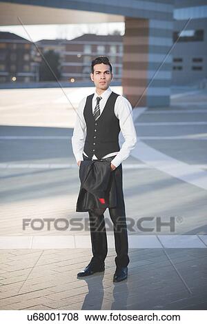 Young businessman carrying jacket View Large Photo Image Stock Photo - Young businessman carrying jacket. Fotosearch