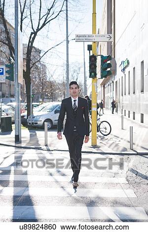 "Young businessman in the street, Milan, Italy" View Large Photo Image Stock Image - "Young businessman in the street, Milan, Italy". Fotosearch