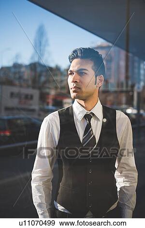 Stock Photo - Young businessman in the street. Fotosearch