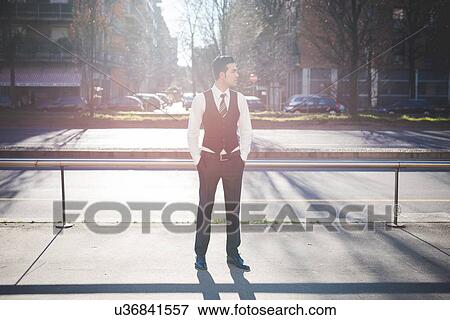 Stock Photo - "Young businessman in the street, Milan, Italy". Fotosearch