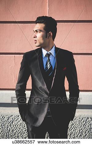 Stock Photo - Young businessman in the street. Fotosearch