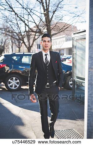 Stock Photo - "Young businessman in the street, Milan, Italy". Fotosearch
