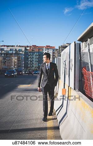 Stock Photograph - "Young businessman in the street, Milan, Italy". Fotosearch