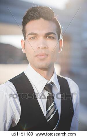 Young businessman looking at camera View Large Photo Image Stock Photo - Young businessman looking at camera. Fotosearch