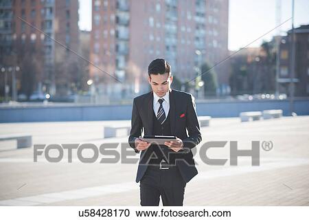 Young businessman using digital tablet View Large Photo Image Stock Image - Young businessman using digital tablet. Fotosearch