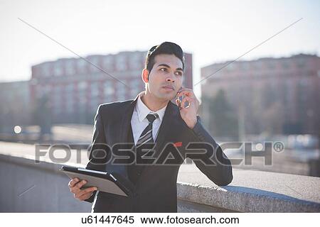 Young businessman using digital tablet on rooftop View Large Photo Image Stock Photography - Young businessman using digital tablet on rooftop. Fotosearch