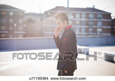 Young businessman using smartphone View Large Photo Image Picture - Young businessman using smartphone. Fotosearch