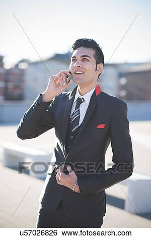 Stock Photograph - Young businessman using smartphone. Fotosearch