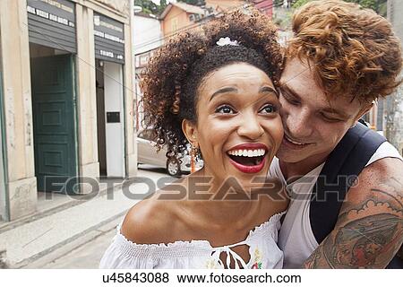 "Young couple fooling around in street, laughing, close-up" View Large Photo Image Stock Photo - "Young couple fooling around in street, laughing, close-up". Fotosearch