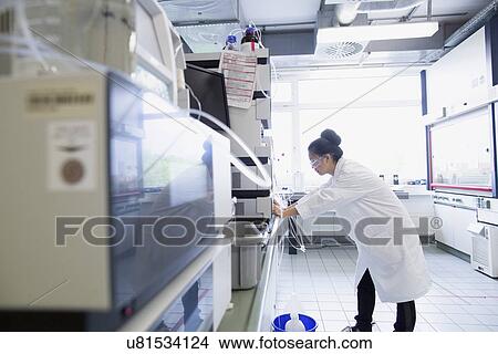 Young female scientist using scientific equipment in lab View Large Photo Image Picture - Young female scientist using scientific equipment in lab. Fotosearch