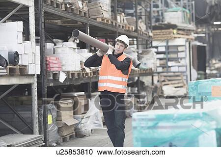 Young male warehouse worker carrying industrial pipe on shoulder View Large Photo Image Stock Image - Young male warehouse worker carrying industrial pipe on shoulder. Fotosearch