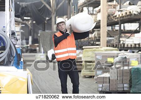 Young male warehouse worker carrying polystyrene roll on shoulder View Large Photo Image Stock Image - Young male warehouse worker carrying polystyrene roll on shoulder. Fotosearch