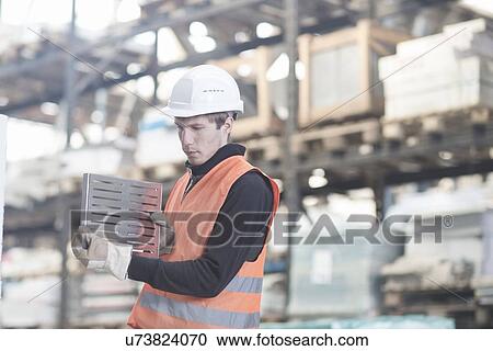 Young male warehouse worker steel product in warehouse View Large Photo Image Stock Image - Young male warehouse worker steel product in warehouse. Fotosearch