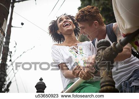 "Young man and woman, standing together, laughing, low angle view" View Large Photo Image Stock Image - "Young man and woman, standing together, laughing, low angle view". Fotosearch