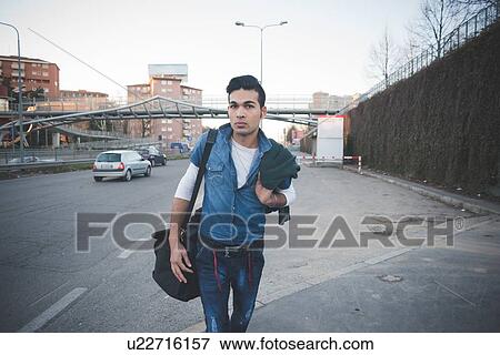 Stock Photo - "Young man in the street, Milan, Italy". Fotosearch