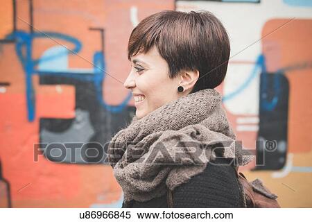 Young woman by graffiti wall View Large Photo Image Stock Photography - Young woman by graffiti wall. Fotosearch