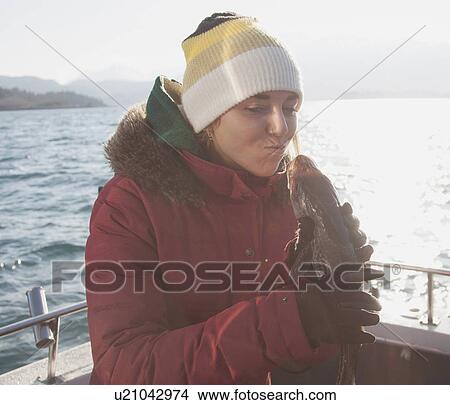 Young woman holding fish on boat View Large Photo Image Picture - Young woman holding fish on boat. Fotosearch