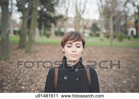 Young woman in park View Large Photo Image Stock Image - Young woman in park. Fotosearch