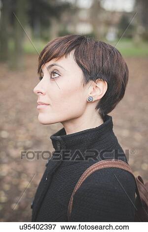 Stock Photo - Young woman in park. Fotosearch