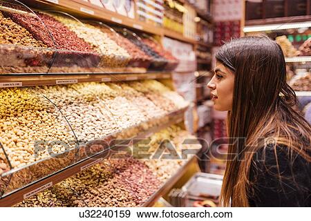 "Young woman looking at foods in market, Istanbul, Turkey" View Large Photo Image Stock Photo - "Young woman looking at foods in market, Istanbul, Turkey". Fotosearch