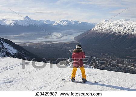 Stock Photo - "Young woman on snowboard, Girdwood, Anchorage, Alaska". Fotosearch