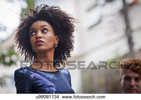 Picture - "Young woman, outdoors, looking away". Fotosearch