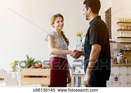 Young woman shaking mans hand View Large Photo Image Stock Photography - Young woman shaking mans hand. Fotosearch
