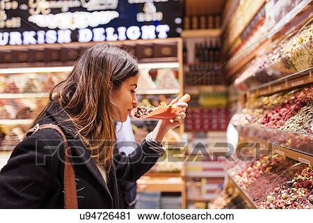 "Young woman smelling food in market, Istanbul, Turkey" View Large Photo Image Stock Image - "Young woman smelling food in market, Istanbul, Turkey". Fotosearch