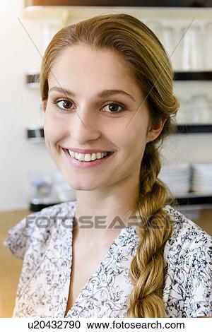 "Young woman smiling at camera, portrait" View Large Photo Image Stock Image - "Young woman smiling at camera, portrait". Fotosearch