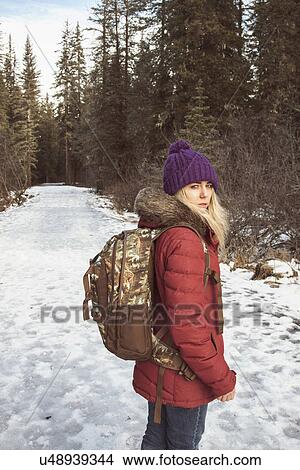 Picture - "Young woman wearing winter clothes and backpack, Girdwood, Anchorage, Alaska". Fotosearch