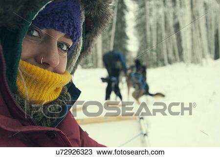 Stock Image - "Young woman wearing winter clothing, close up". Fotosearch