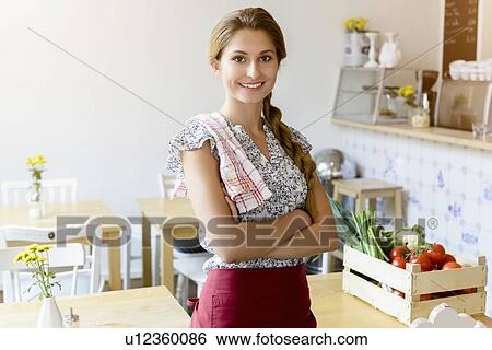 Young woman working in cafe smiling at camera View Large Photo Image Stock Photograph - Young woman working in cafe smiling at camera. Fotosearch