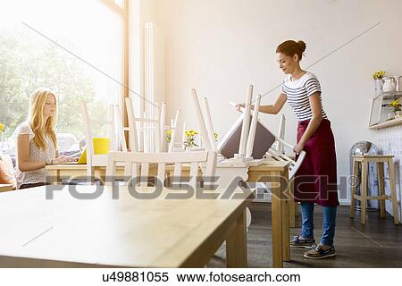 Young women preparing for work in cafe View Large Photo Image Stock Photography - Young women preparing for work in cafe. Fotosearch
