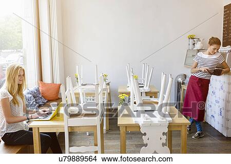 Picture - Young women working in cafe. Fotosearch