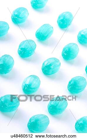 Stock Image - Blue candies on white background. Fotosearch