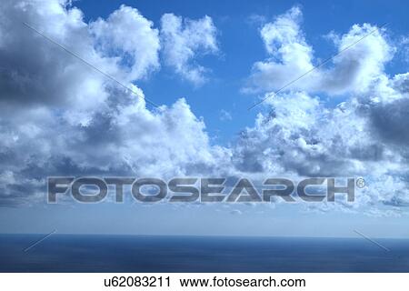 Stock Image - blue sky background with tiny clouds. Fotosearch