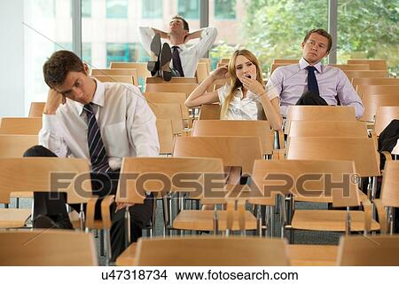 bored Business executives sitting in conference room View Large Photo Image Picture - bored Business executives sitting in conference room. Fotosearch