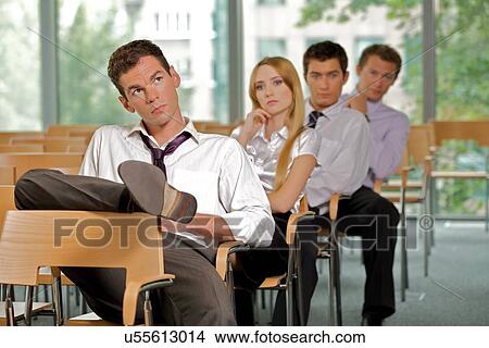 Picture - Business executives sitting in row at office. Fotosearch