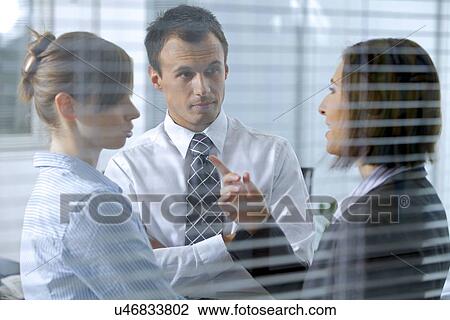 Business people conversing in office View Large Photo Image Stock Image - Business people conversing in office. Fotosearch