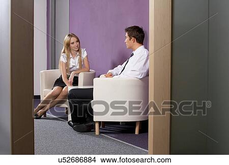 Businessman and businesswoman discussing in office View Large Photo Image Picture - Businessman and businesswoman discussing in office. Fotosearch