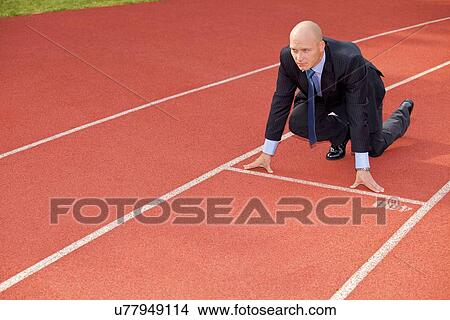 Businessman at the start line of running track View Large Photo Image Picture - Businessman at the start line of running track. Fotosearch