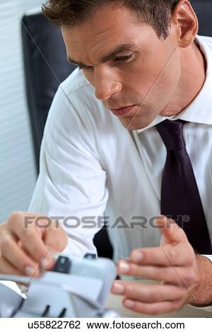 Businessman at work in office View Large Photo Image Stock Image - Businessman at work in office. Fotosearch