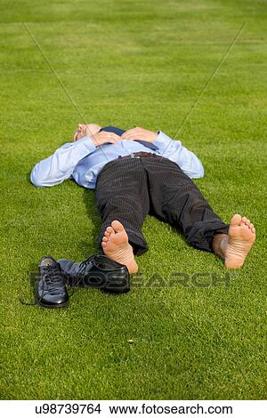 Businessman relaxing in park View Large Photo Image Picture - Businessman relaxing in park. Fotosearch