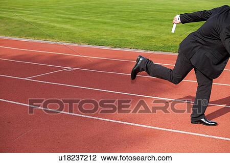 Businessman running on race track View Large Photo Image Stock Image - Businessman running on race track. Fotosearch