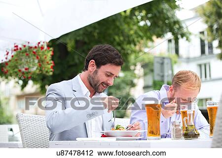 Businessmen eating food at outdoor restaurant View Large Photo Image Stock Image - Businessmen eating food at outdoor restaurant. Fotosearch