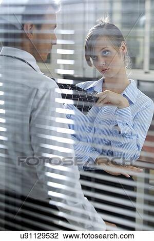 Businesswoman flirting with his colleague in office View Large Photo Image Stock Image - Businesswoman flirting with his colleague in office. Fotosearch