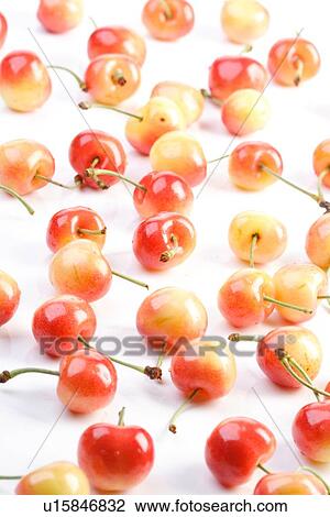 Stock Image - Cherries on white background - close up. Fotosearch