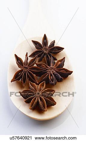 Stock Image - Close up of anise on wooden spoon. Fotosearch