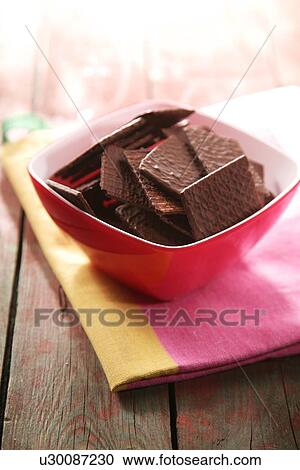 Stock Image - Close-up of chocolate cookies in bowl. Fotosearch